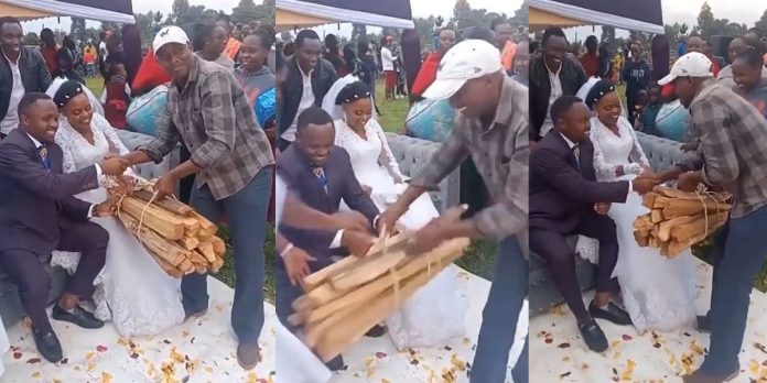 “It’s a bad omen” – Mixed reactions as man gifts bundle of firewood to couple on wedding day (Video)