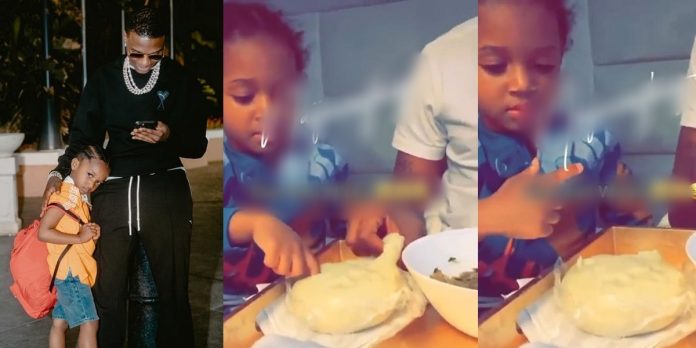 Video of singer Wizkid teaching his son, Zion how to eat ‘fufu’ causes stir online (Watch)