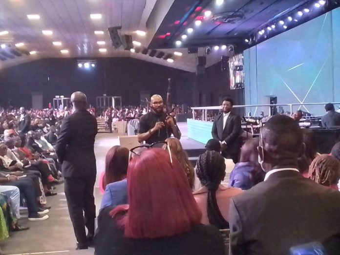 Pastor holds Ak 47 rifle in church