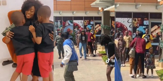 “She knows her job” – Viral video of nanny covering faces of Funke Akindele’s twins in public stirs reactions (Watch)