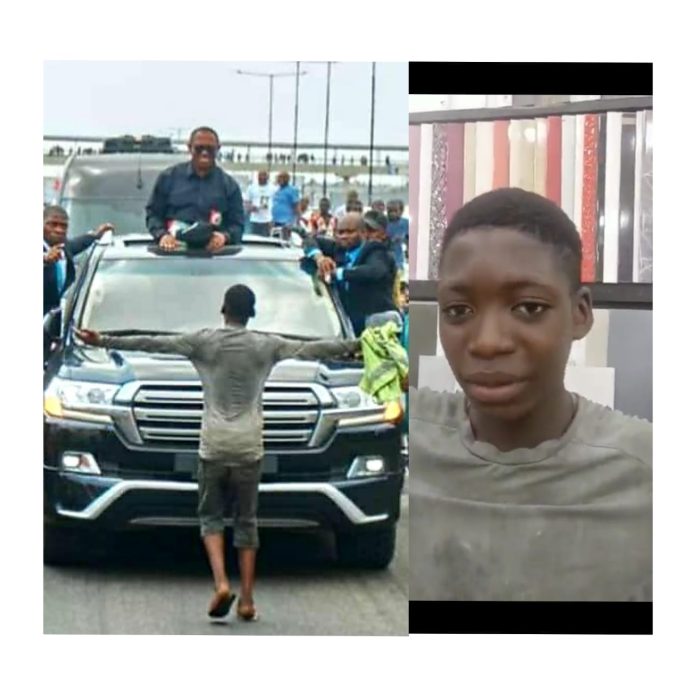 Teenager standing in front of Obi’s vehicle