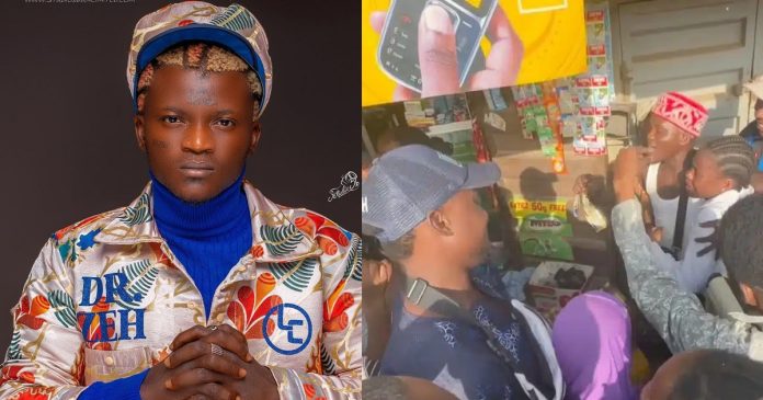 Portable shows his benevolent side as he buys and share groceries to residents and gifts N100K to a student