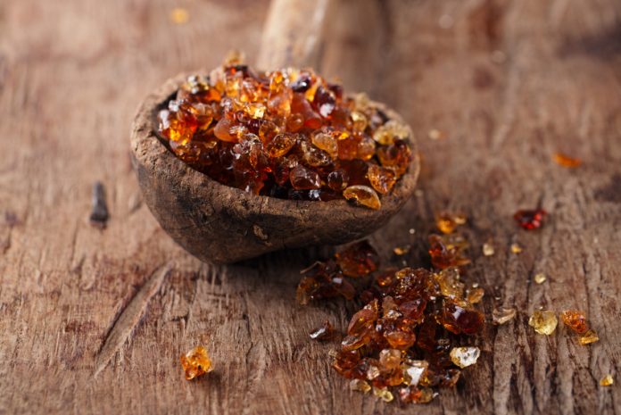 Gum arabic, also known as acacia gum – in  old wooden spoon