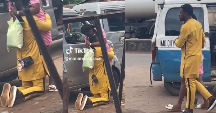 Nigerian man goes down on his knees in motor park to propose to his girlfriend (Video)