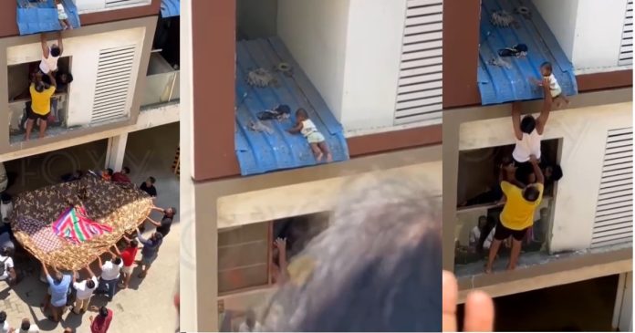 Baby decides to reunite community as the climbs to the roof of a story building (VIDEO)