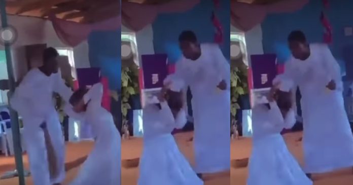 Video of pastor casting out the d€mon in his female member's body with broom sparks reaction online (VIDEO)