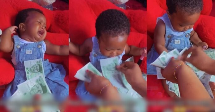 Moment Baby Stops Crying When Sprayed With Money Stirs Reactions Online (VIDEO)