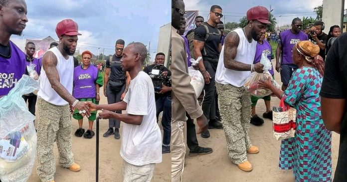 Singer Burna Boy warms heart, shares food items with people in Port Harcourt (VIDEO)