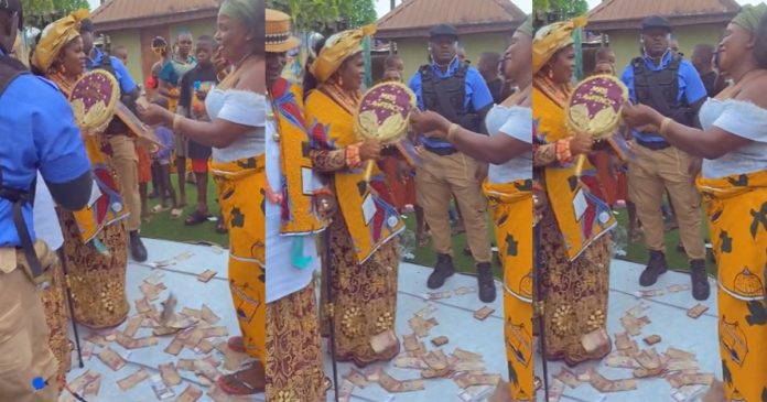 Lady is astonished as her boyfriend's mother sprays bundles of naira notes at her sister's wedding (VIDEO)