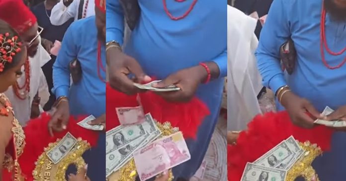 Man discards ₦200 notes while spraying dollars at a wedding ceremony (WATCH)