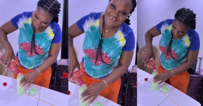 Lady Caúght on Camera Pouring Alc0hol into a Bottle to Sneak into NYSC Orientation Camp (WATCH)