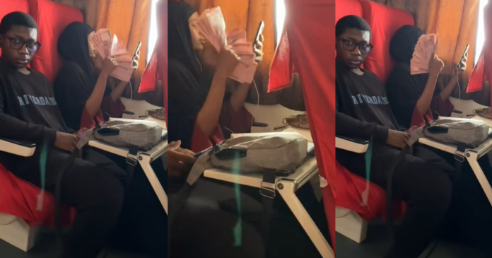 Lady Flaunts Wealth, Fans Herself with ₦200 Mint Notes Inside Train (VIDEO)
