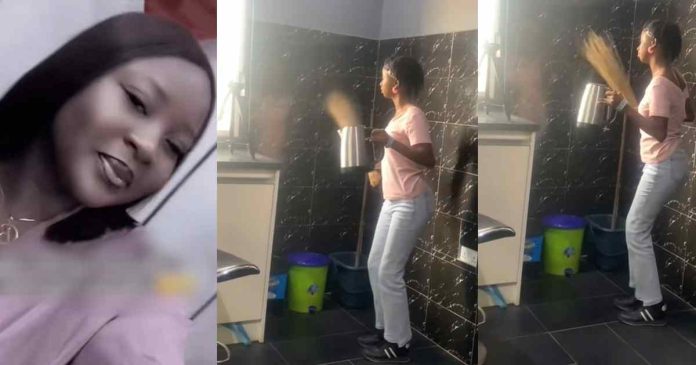 Woman surprised after finding her colleague dancing before a camera in the office's kitchen (Video)