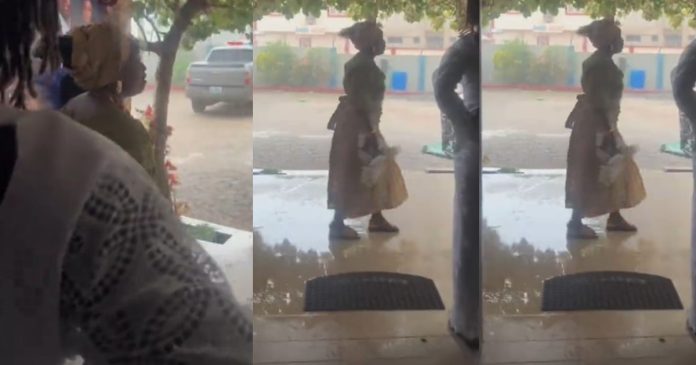 Nigerian mum prays fervently after heavy downpour began on her son's wedding day.