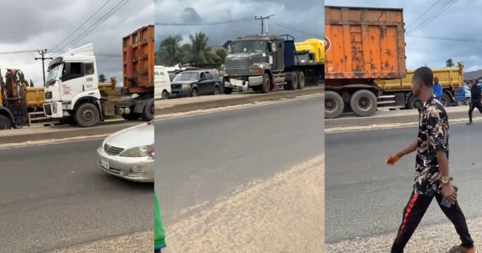 Panic as two heavy trucks drive on pavement to beat Panic as two heavy trucks drive on pavement to beat gridlock on major road (Watch)